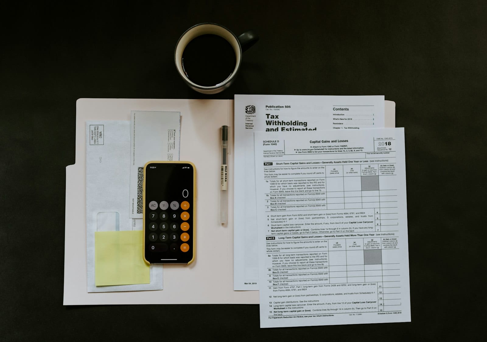 Planner with annual financial goals written next to a laptop and coffee cup
