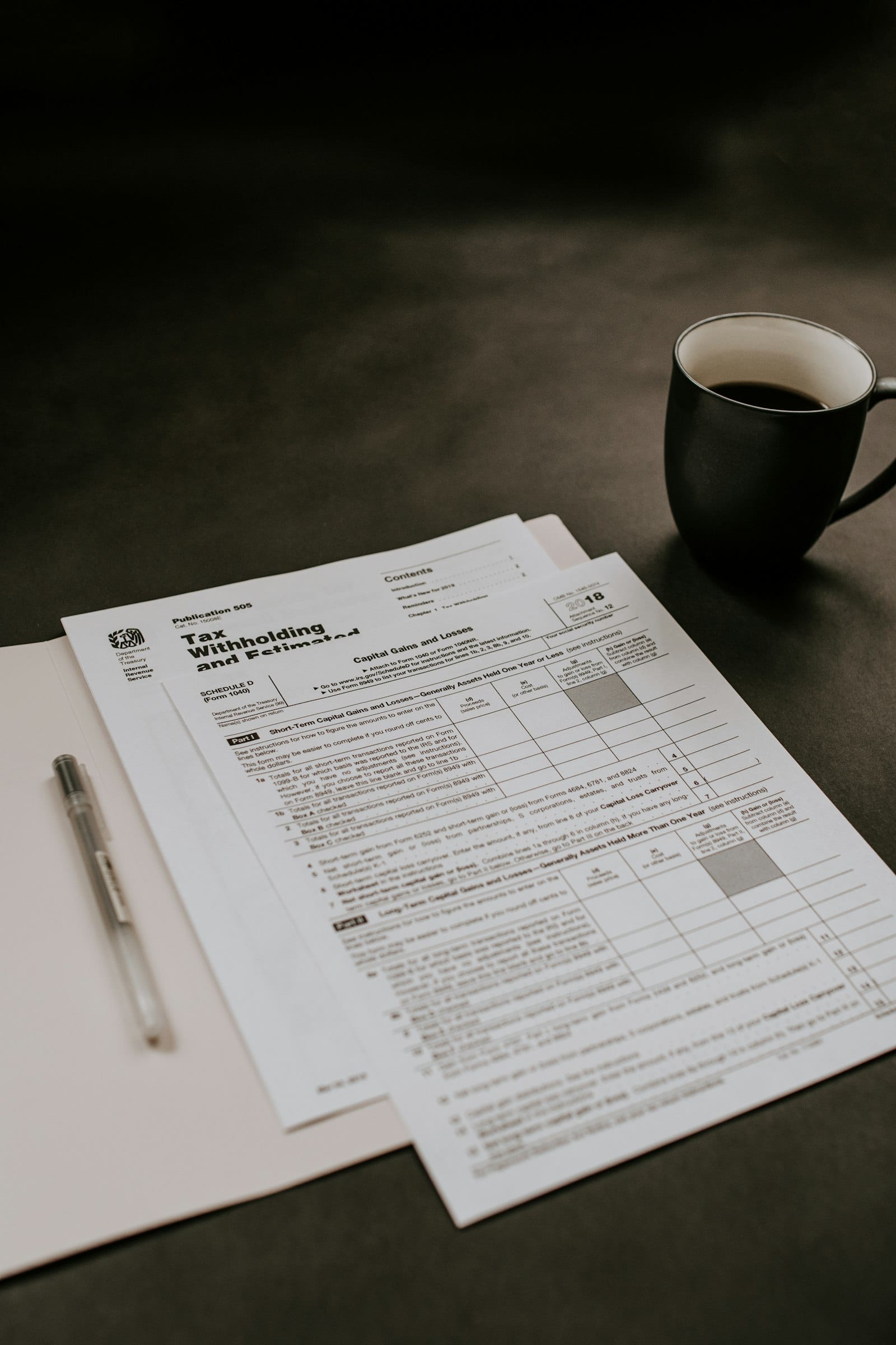 Calculator, pen and spreadsheet on a desk used to plan monthly money management