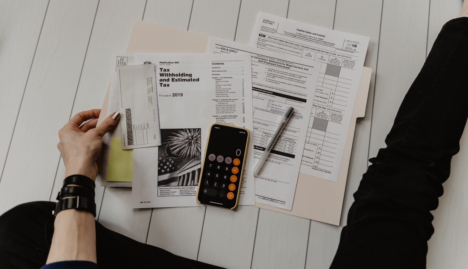 A person studying financial documents with a thoughtful expression